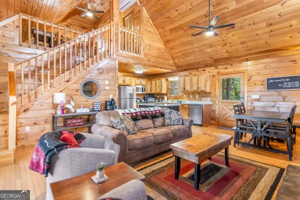 a living room with furniture a table and chairs