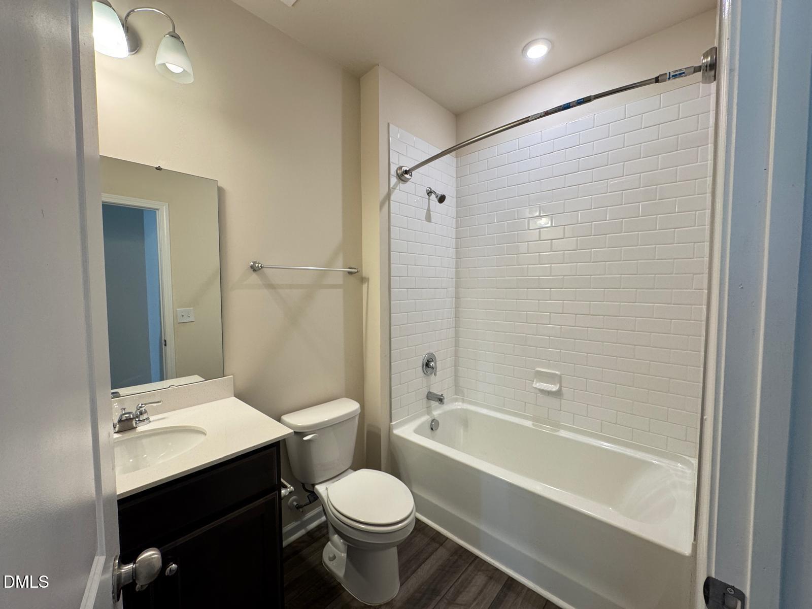 3440 Pinnacle Peak Drive Raleigh, NC 27604 - Photo 11 of 31 a bathroom with a bathtub shower sink vanity mirror and toilet