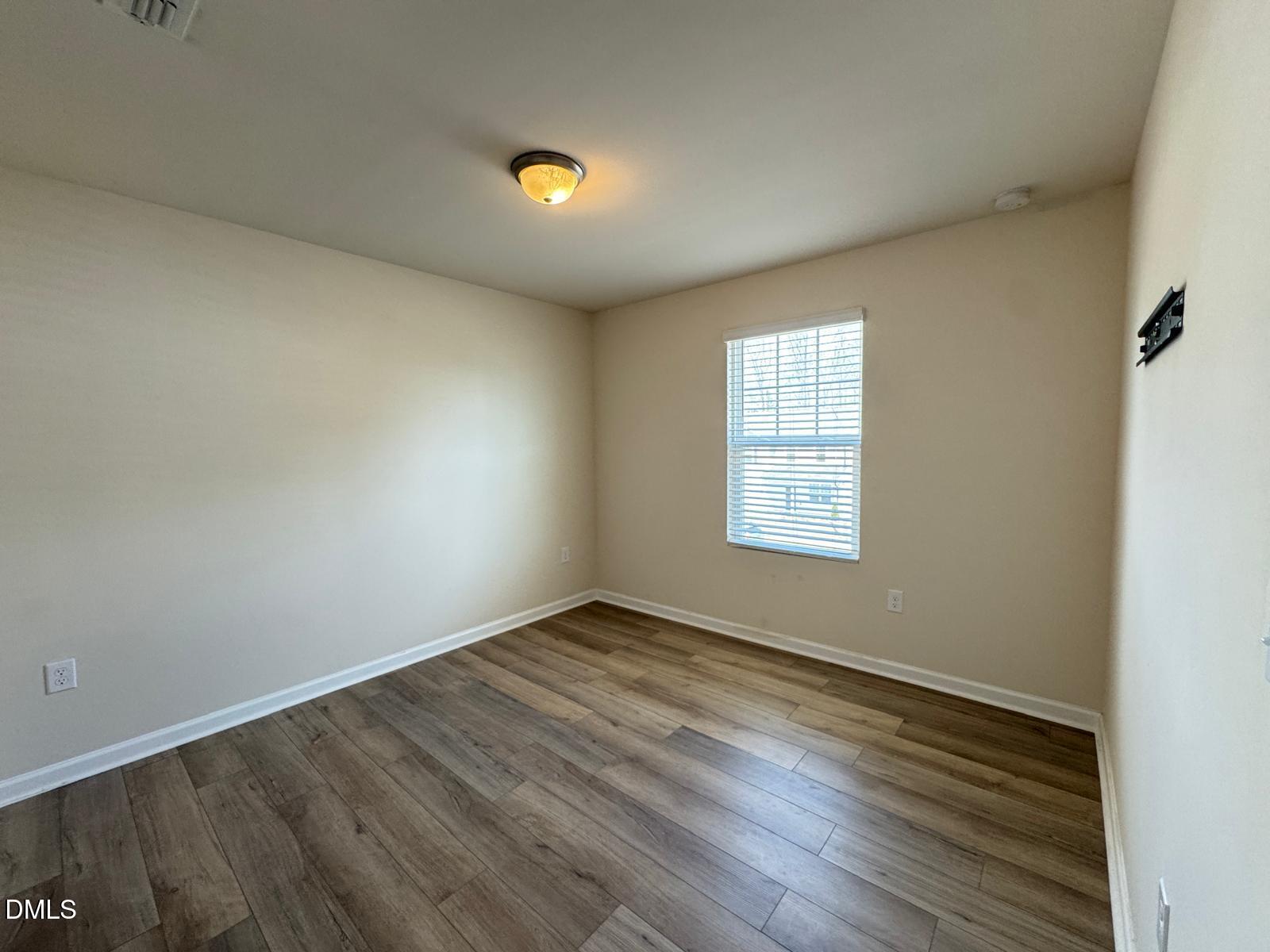 3440 Pinnacle Peak Drive Raleigh, NC 27604 - Photo 12 of 31 an empty room with wooden floor and windows