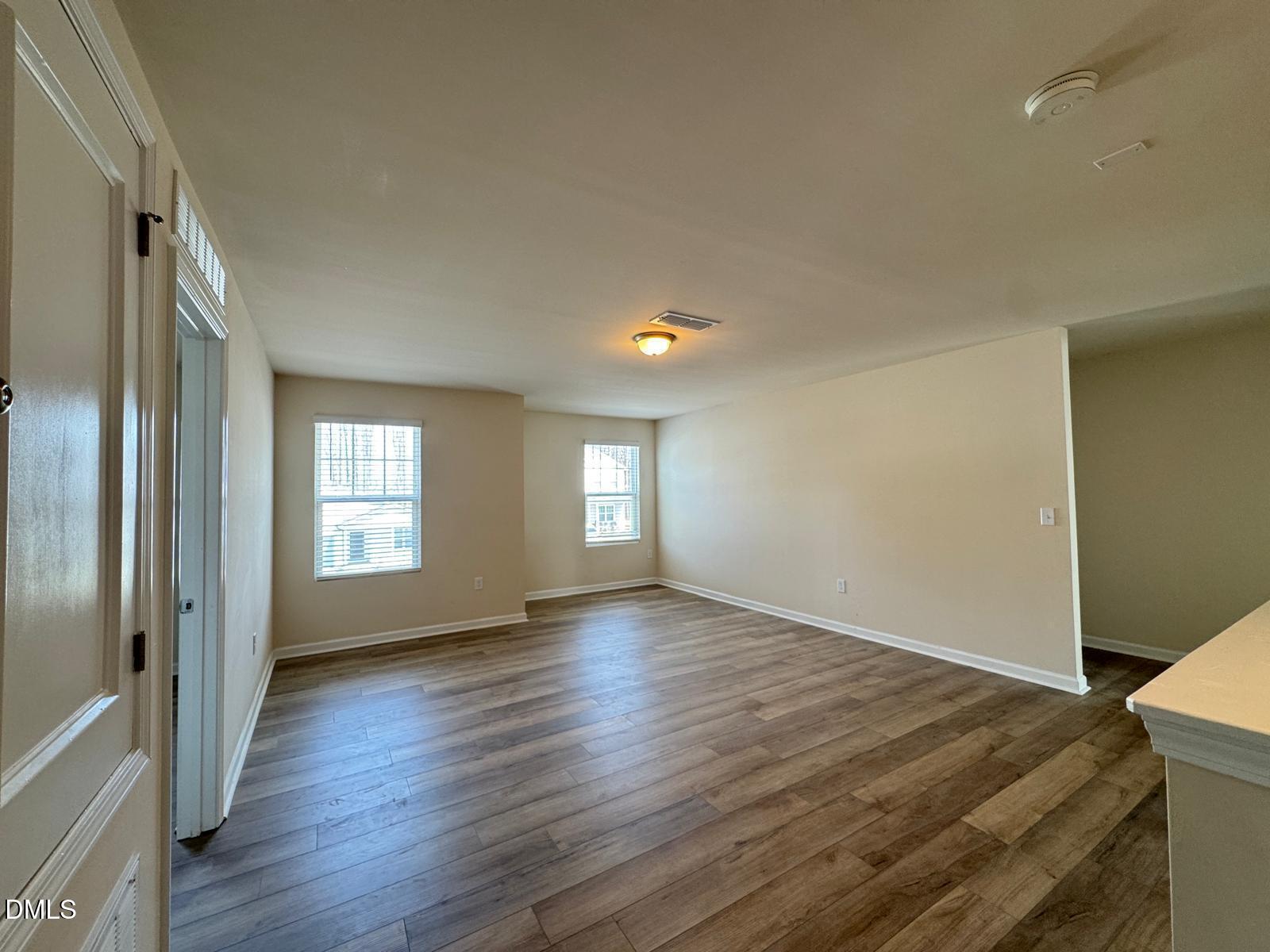 3440 Pinnacle Peak Drive Raleigh, NC 27604 - Photo 14 of 31 an empty room with wooden floor and windows