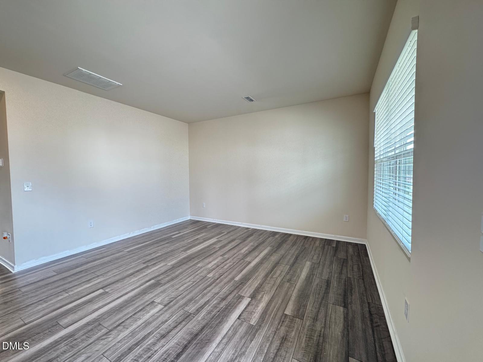 3440 Pinnacle Peak Drive Raleigh, NC 27604 - Photo 2 of 31 wooden floor in an empty room with a window