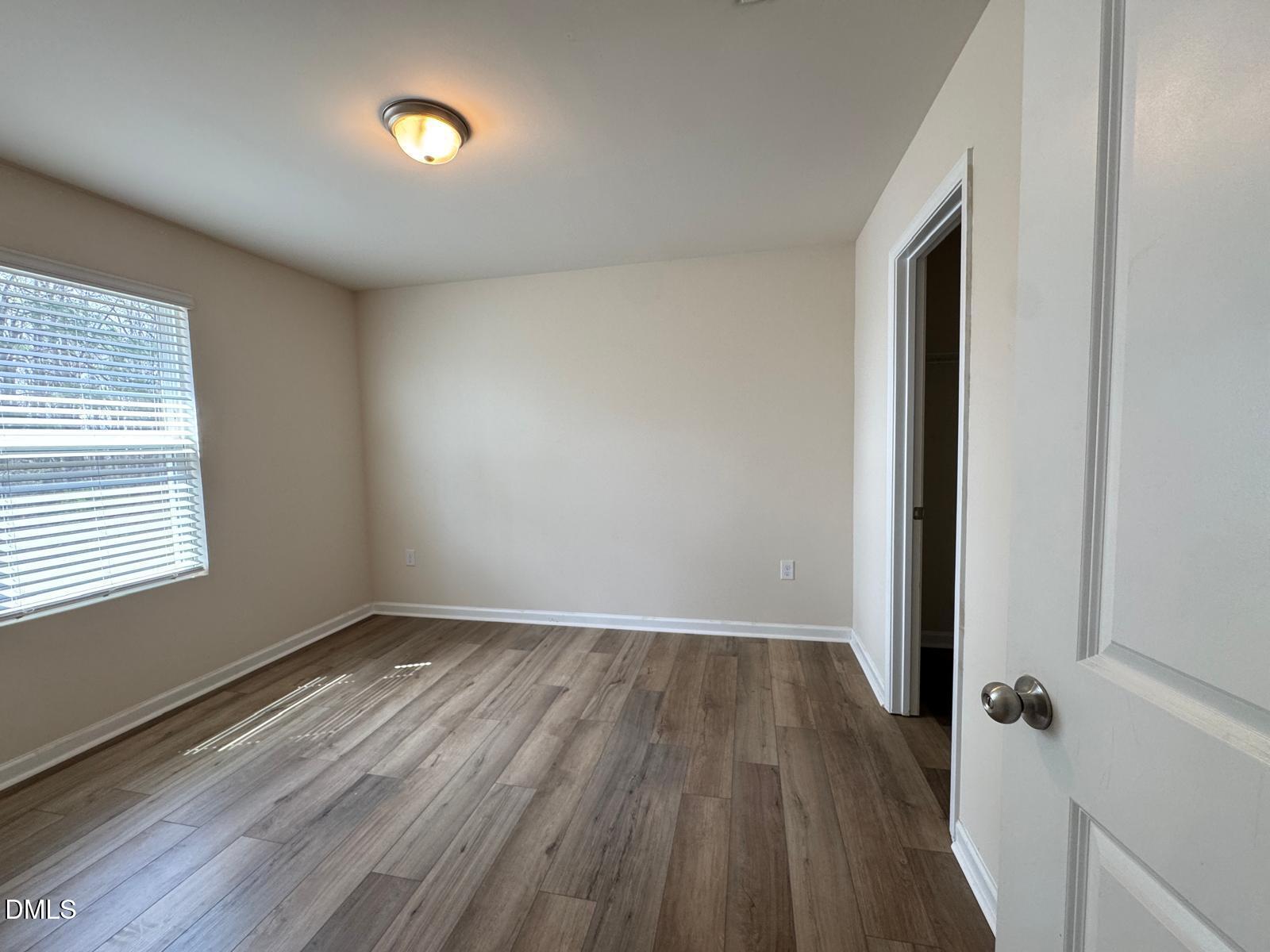 3440 Pinnacle Peak Drive Raleigh, NC 27604 - Photo 26 of 31 an empty room with wooden floor and windows
