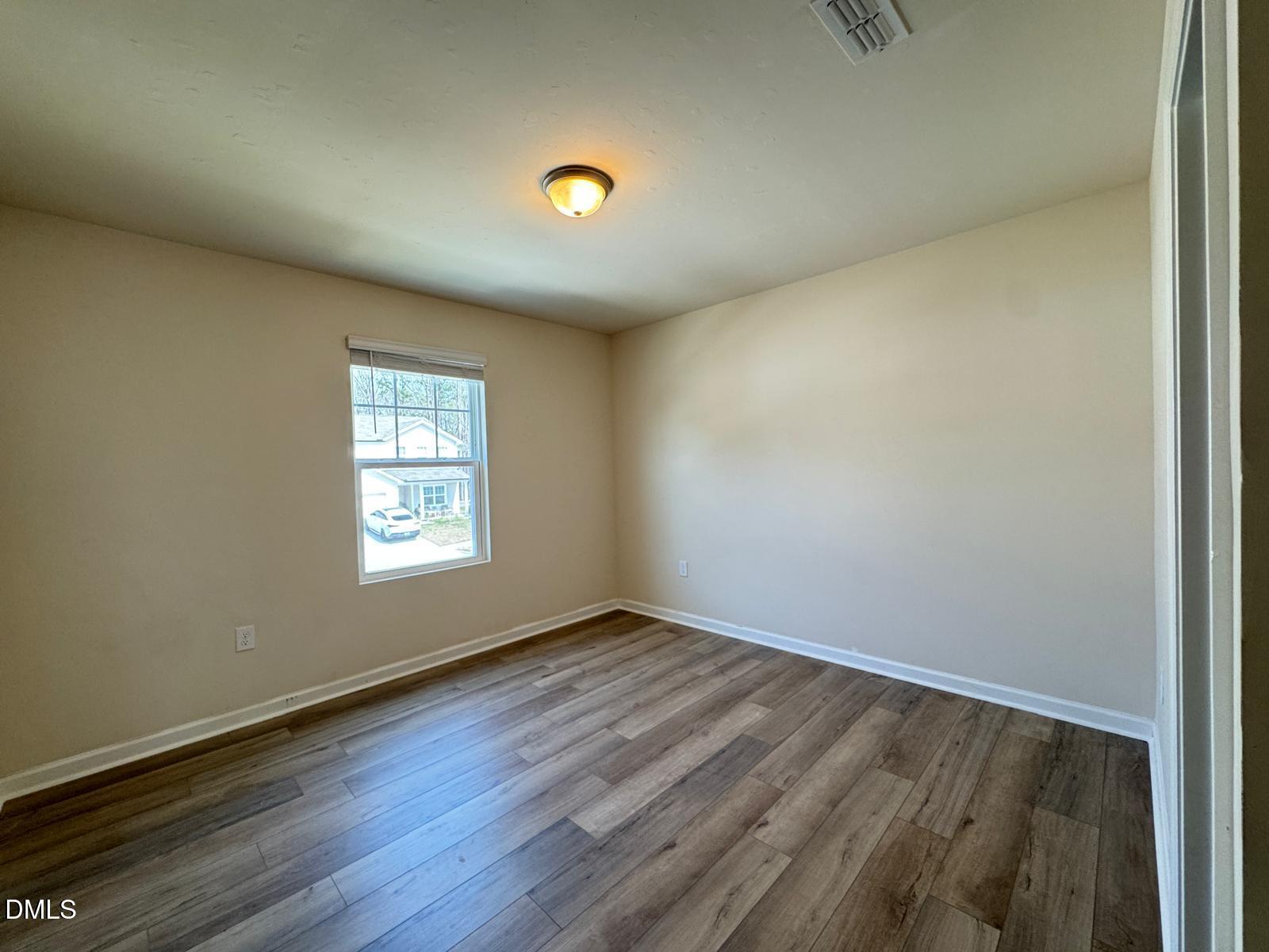 3440 Pinnacle Peak Drive Raleigh, NC 27604 - Photo 28 of 31 an empty room with wooden floor and windows