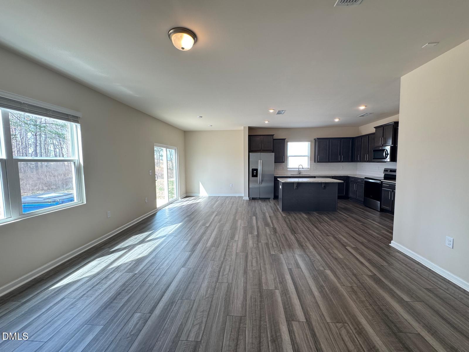 3440 Pinnacle Peak Drive Raleigh, NC 27604 - Photo 5 of 31 a large kitchen with a wooden floor and stainless steel appliances