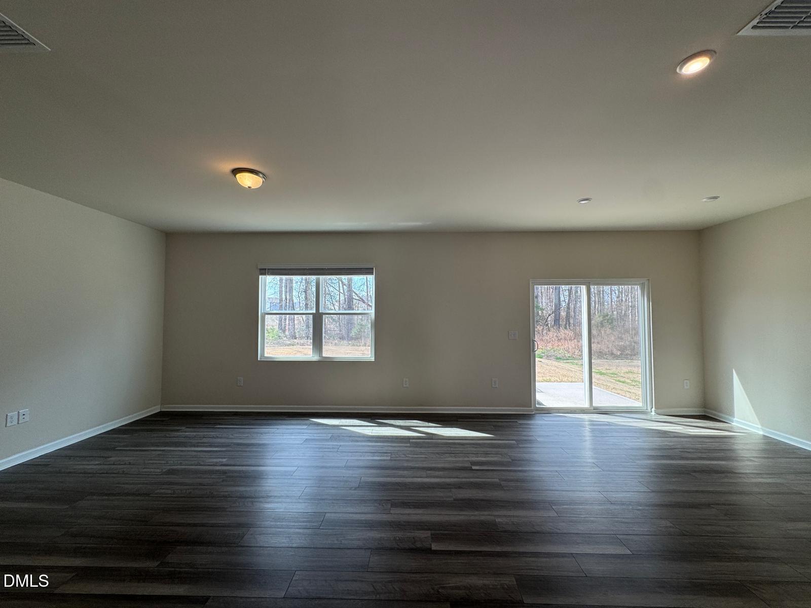 3440 Pinnacle Peak Drive Raleigh, NC 27604 - Photo 7 of 31 an empty room with wooden floor and windows