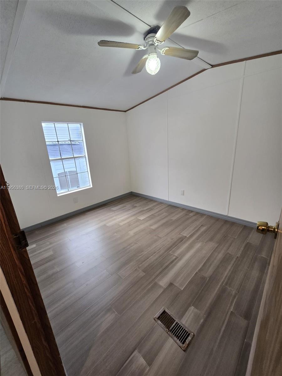 17350 Southwest 232nd Street, Unit 41 Miami, FL 33170 - Photo 12 of 15 wooden floor in an empty room with a window