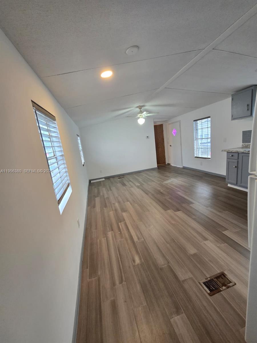 17350 Southwest 232nd Street, Unit 41 Miami, FL 33170 - Photo 14 of 15 an empty room with wooden floor and windows