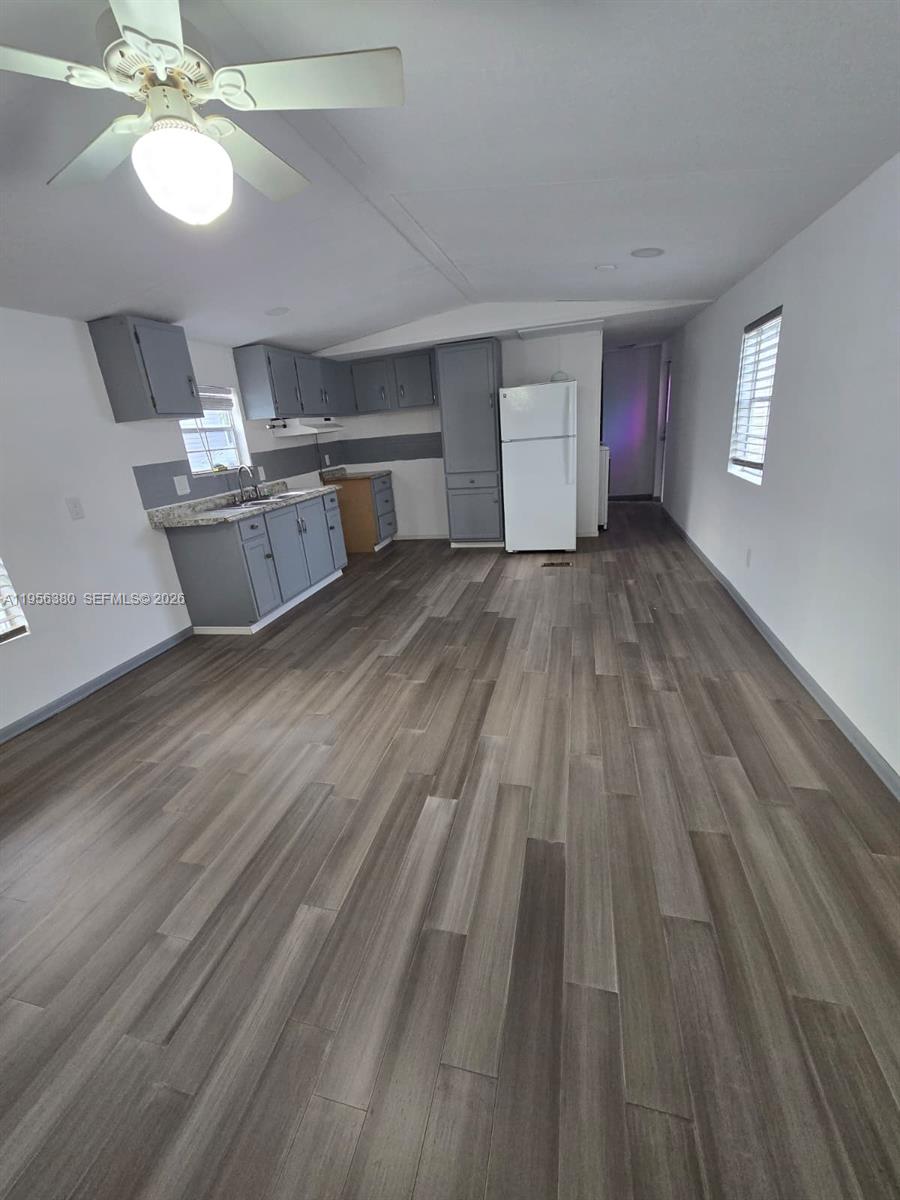 17350 Southwest 232nd Street, Unit 41 Miami, FL 33170 - Photo 6 of 15 a view of empty room with wooden floor and fan