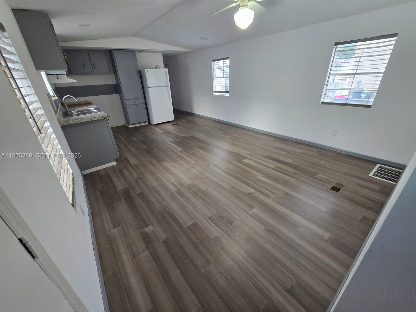 17350 Southwest 232nd Street, Unit 41 Miami, FL 33170 - Photo 7 of 15 wooden floor in an empty room with a window
