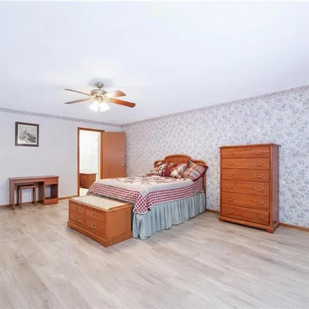 a bedroom with a bed and a chandelier