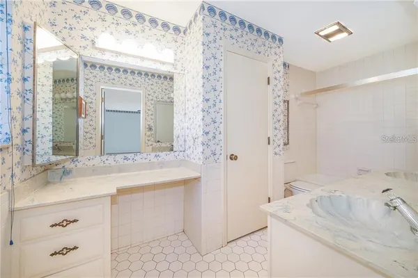 a bathroom with a bathtub sink and mirror