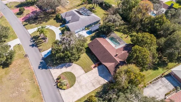 an aerial view of residential house with outdoor space and swimming pool