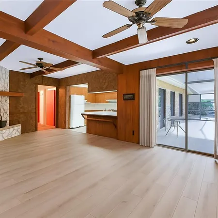 a view of an empty room with a ceiling fan