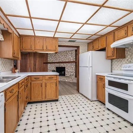 a kitchen with granite countertop a refrigerator and a stove