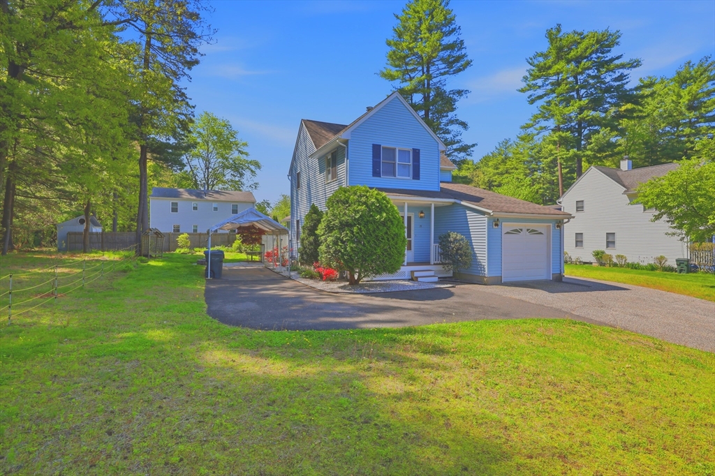 19-21 Wedgewood Circle Springfield, MA 01129 - Photo 3 of 32 a front view of house with yard and trees in the background
