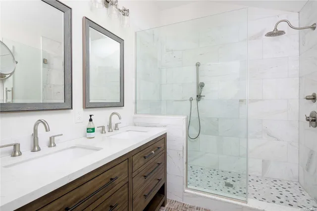 a bathroom with a shower sink and mirror