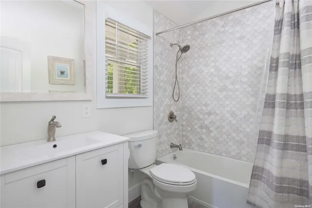 a bathroom with a sink toilet a shower and a mirror