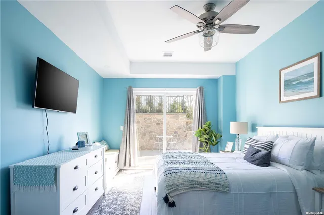 a spacious bedroom with a bed and a flat screen tv