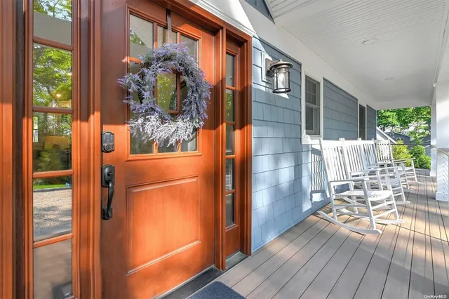 a porch with a table and chairs