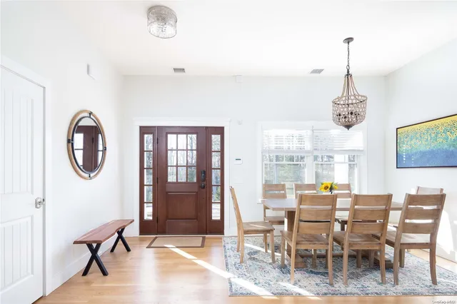 a dining room with furniture a chandelier and a rug