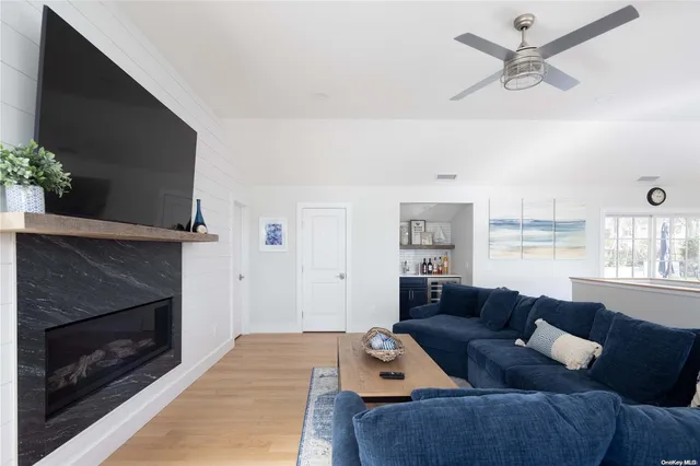 a living room with furniture a flat screen tv and a fireplace