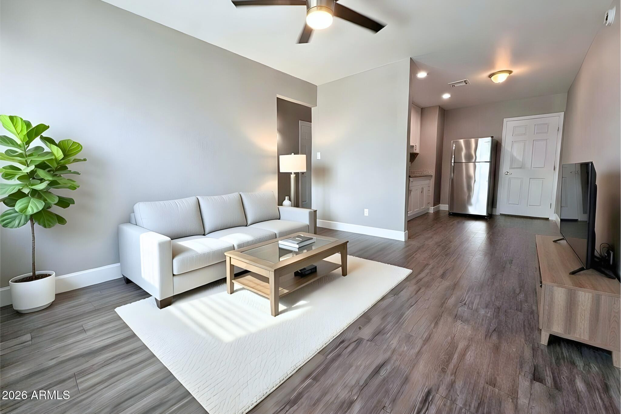 550 West 9th Street, Unit 4 Mesa, AZ 85201 - Photo 3 of 11 a living room with furniture and a flat screen tv