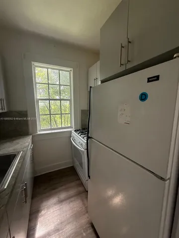 a kitchen with a refrigerator and a sink