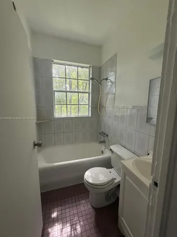 a bathroom with a toilet a sink and bathtub