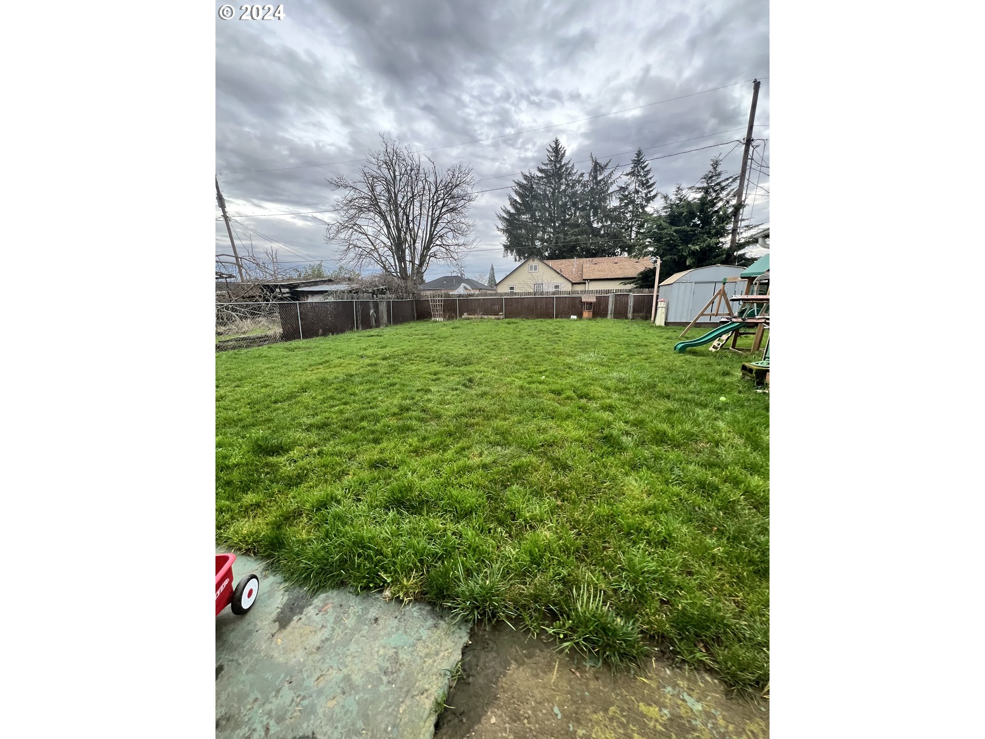 271 22nd Street Springfield, OR 97477 - Photo 18 of 28 a view of a yard with plants and a bench