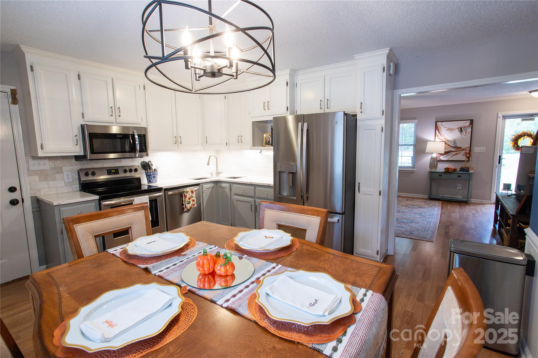 1735 Kallaramo Road Rock Hill, SC 29732 - Photo 12 of 30 a kitchen with stainless steel appliances a dining table a microwave a refrigerator and chairs