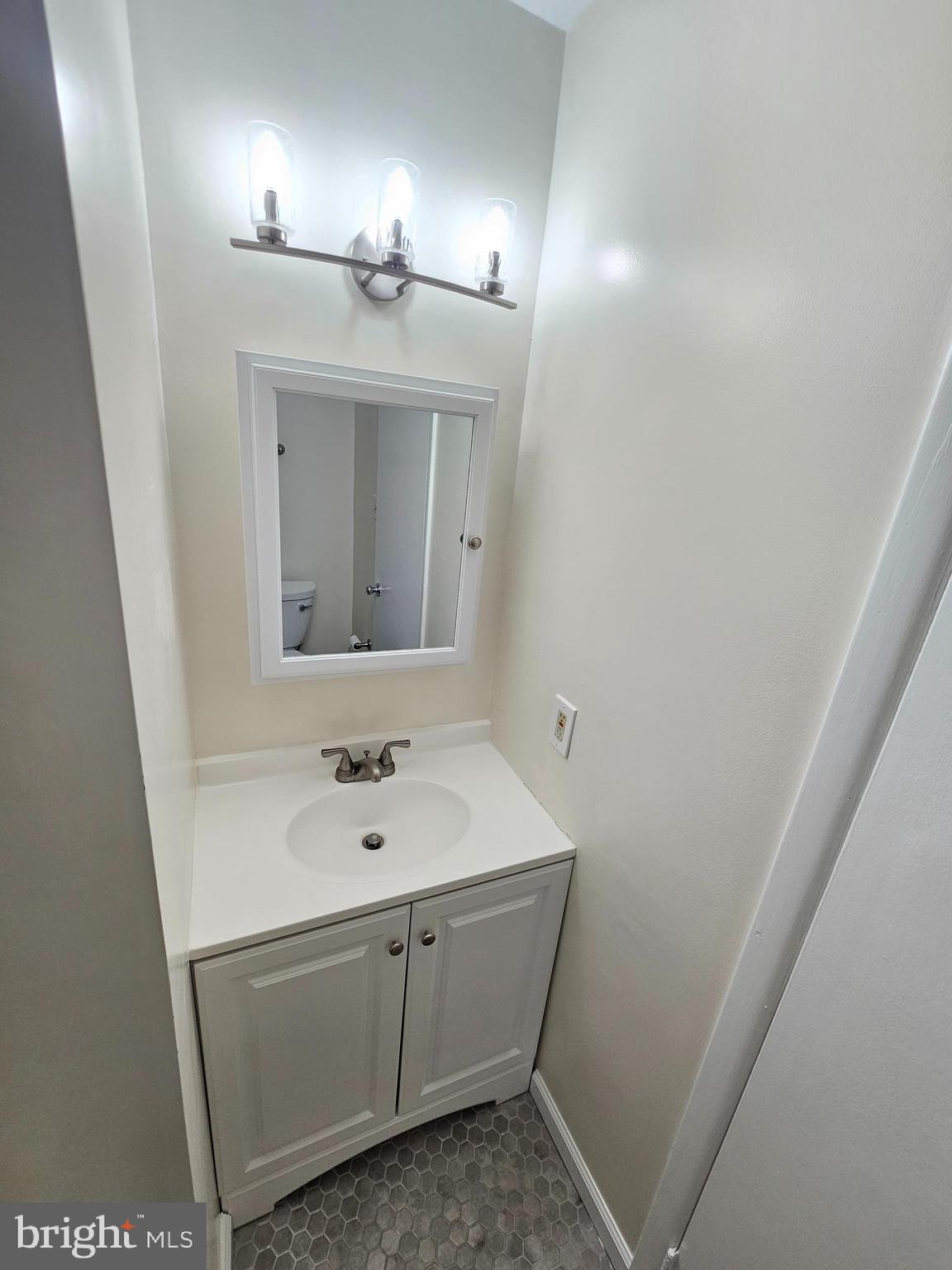 17445 Hoskinson Road Poolesville, MD 20837 - Photo 3 of 37 a bathroom with a sink and a mirror