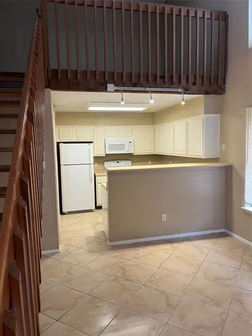 a view of a kitchen with stainless steel appliances and cabinets