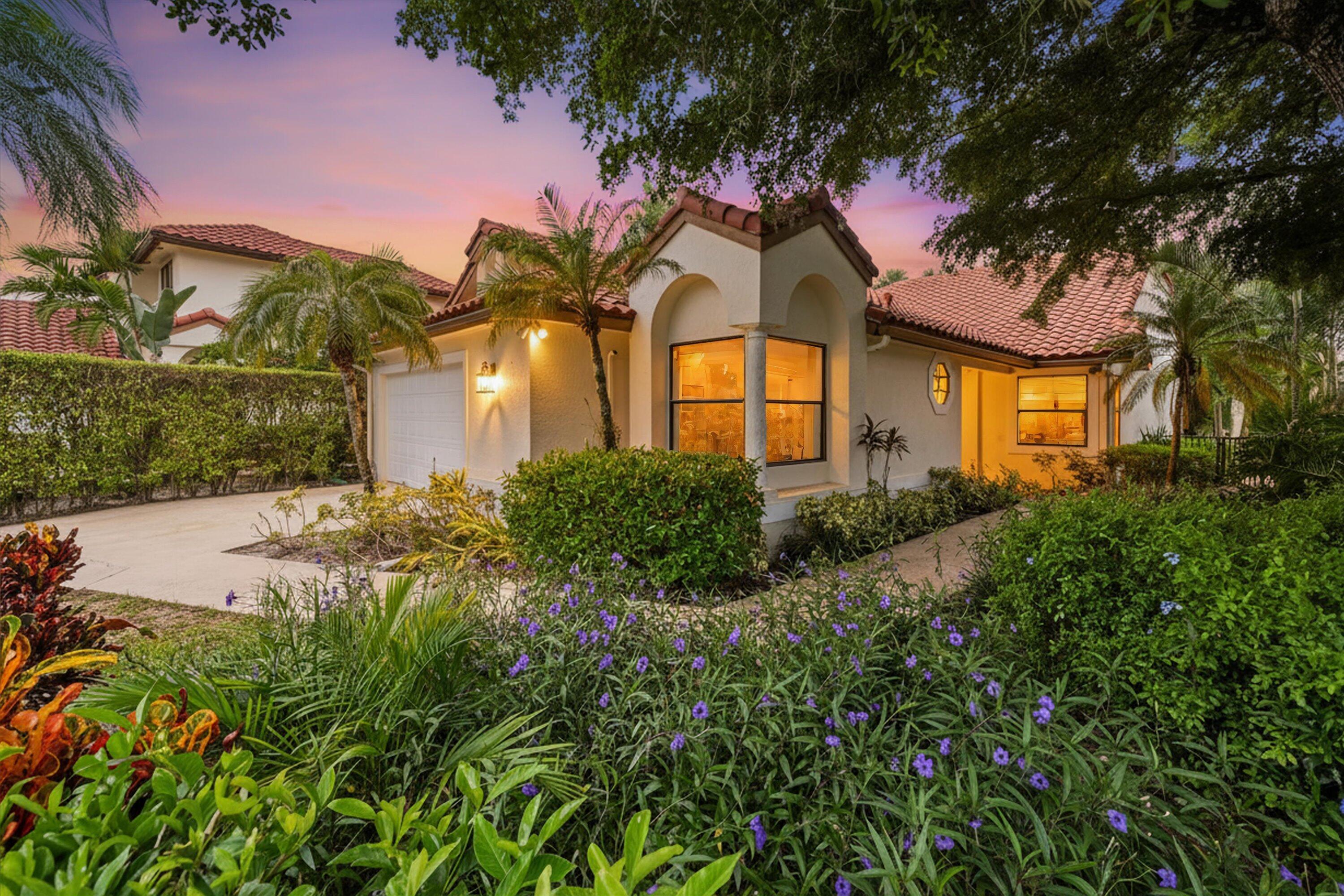 1535 Fairway Terrace West Palm Beach, FL 33411 - Photo 1 of 47 a front view of a house with a yard and potted plants