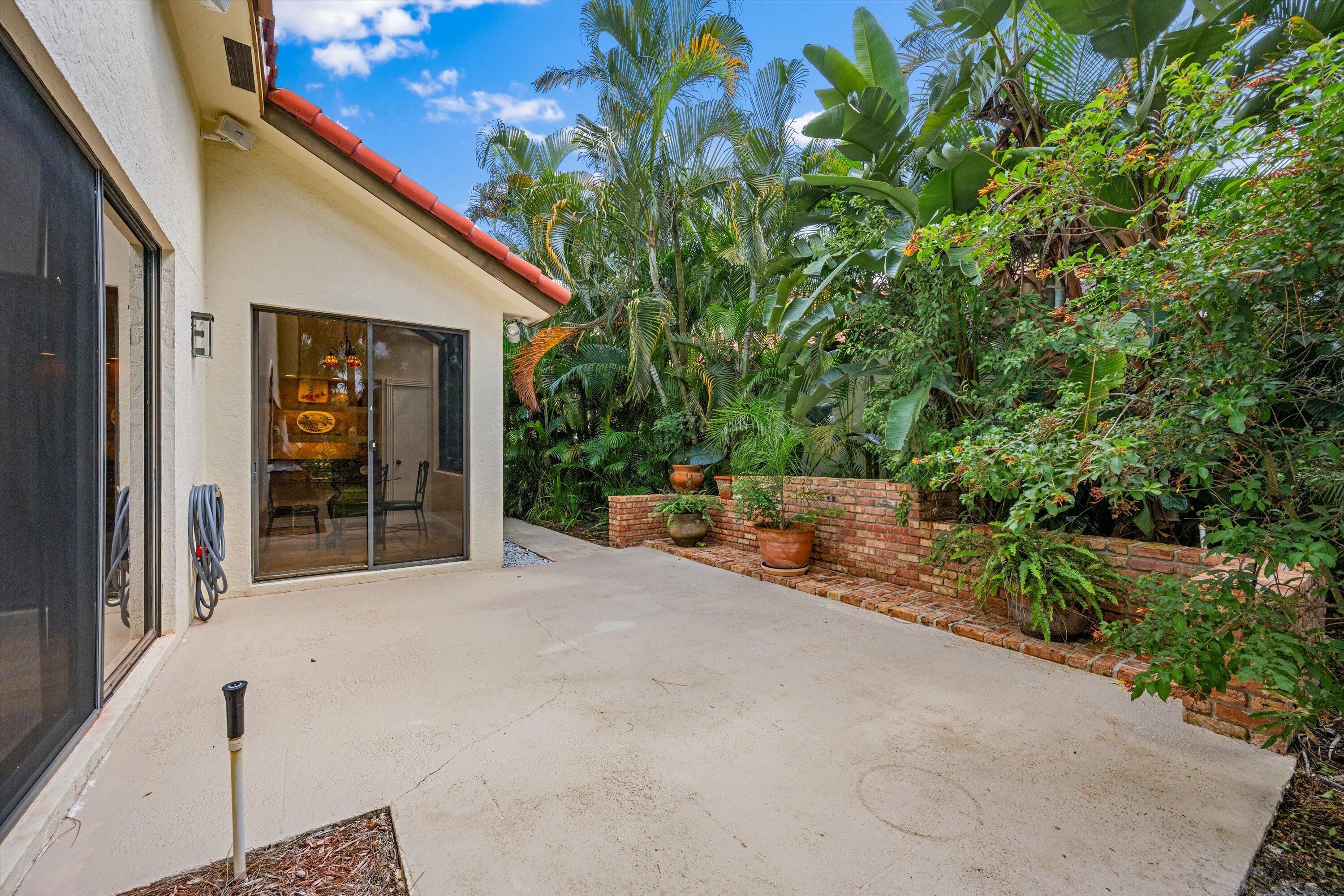 1535 Fairway Terrace West Palm Beach, FL 33411 - Photo 11 of 47 a view of a house with porch and garden