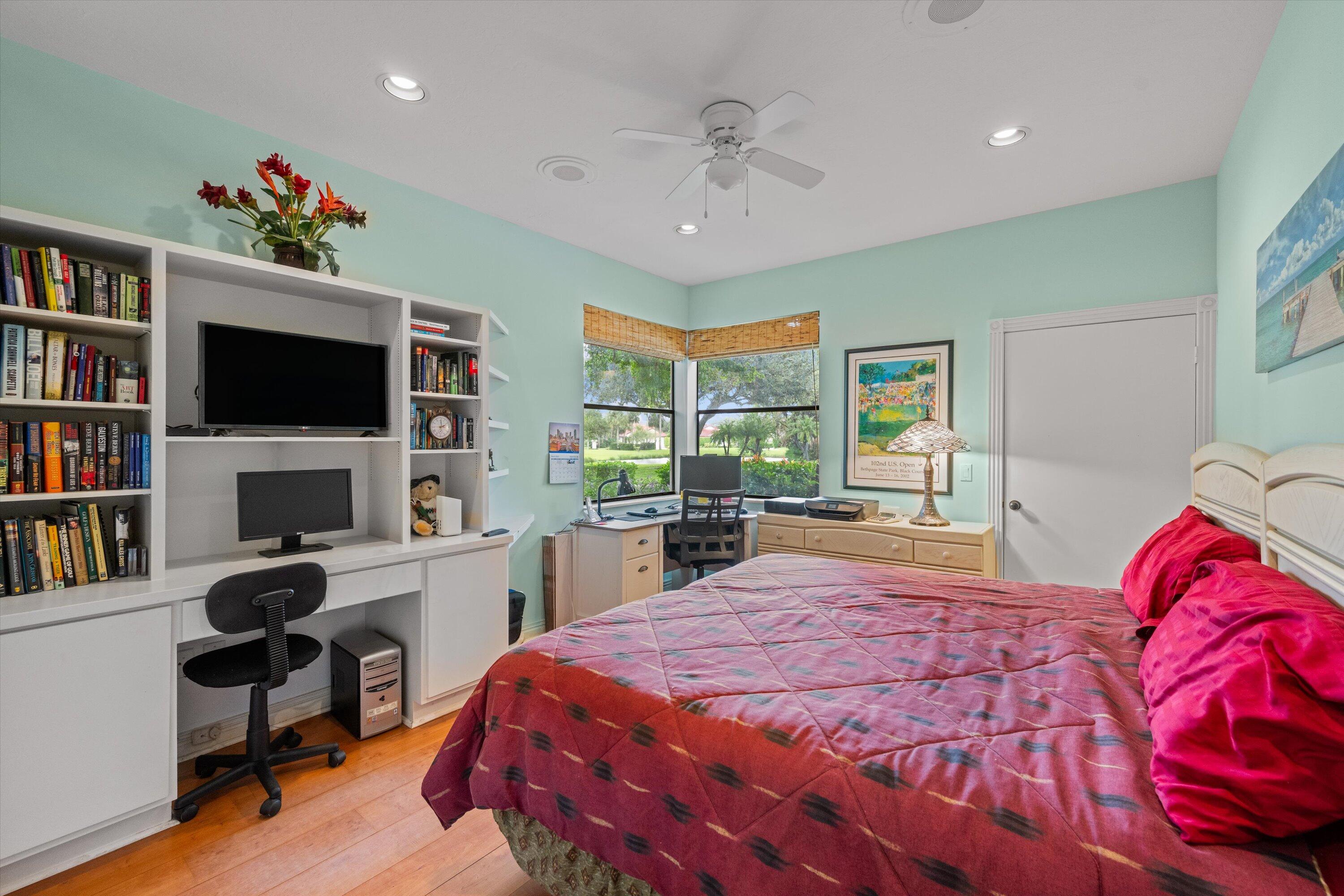 1535 Fairway Terrace West Palm Beach, FL 33411 - Photo 17 of 47 a bed room with a bed a television and a book shelf