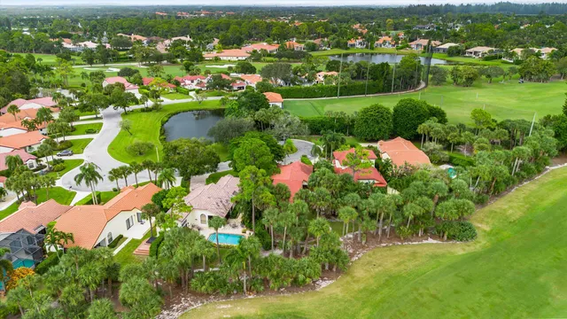 an aerial view of residential houses with outdoor space and trees