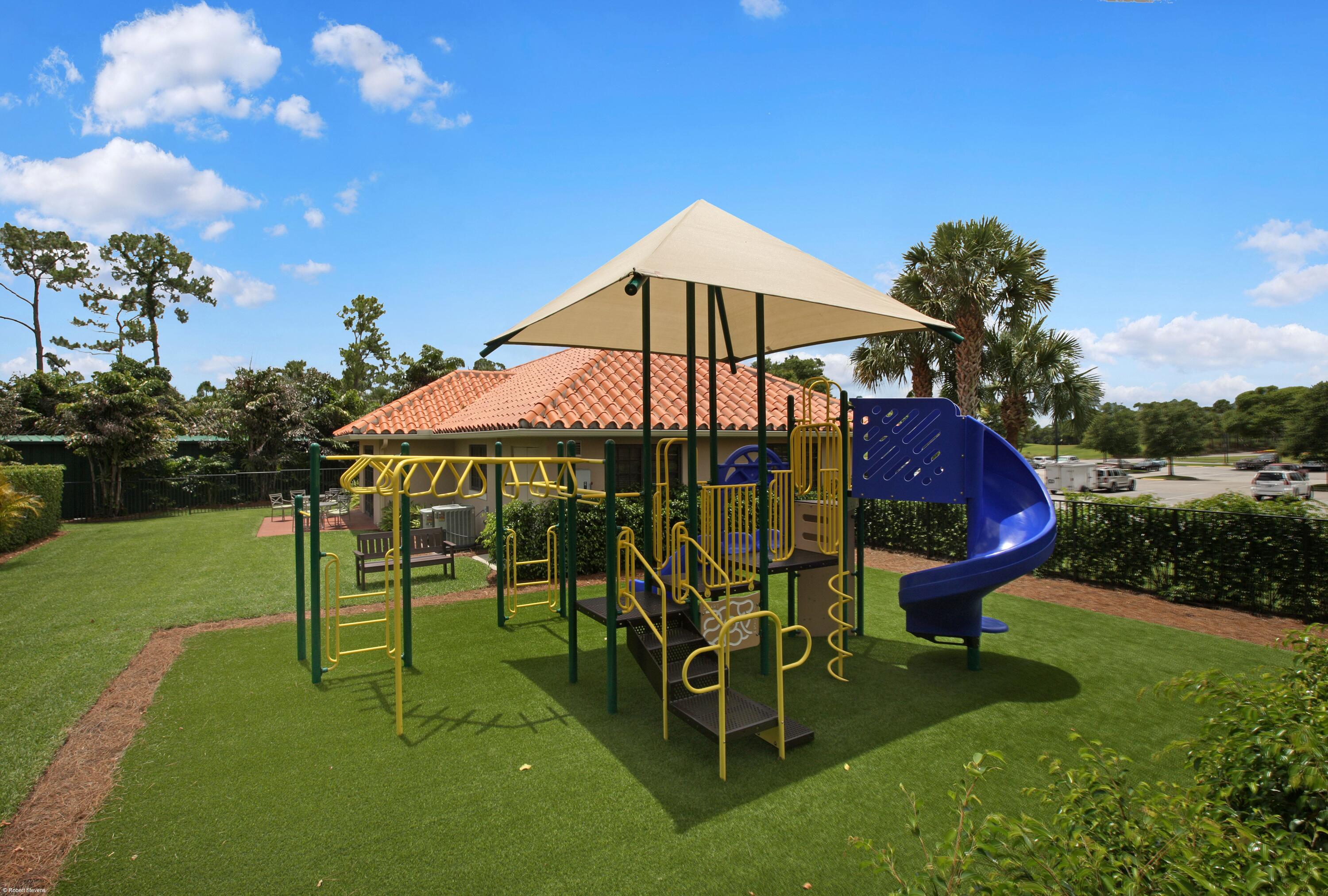 1535 Fairway Terrace West Palm Beach, FL 33411 - Photo 38 of 47 a view of a garden with a table and chairs under an umbrella