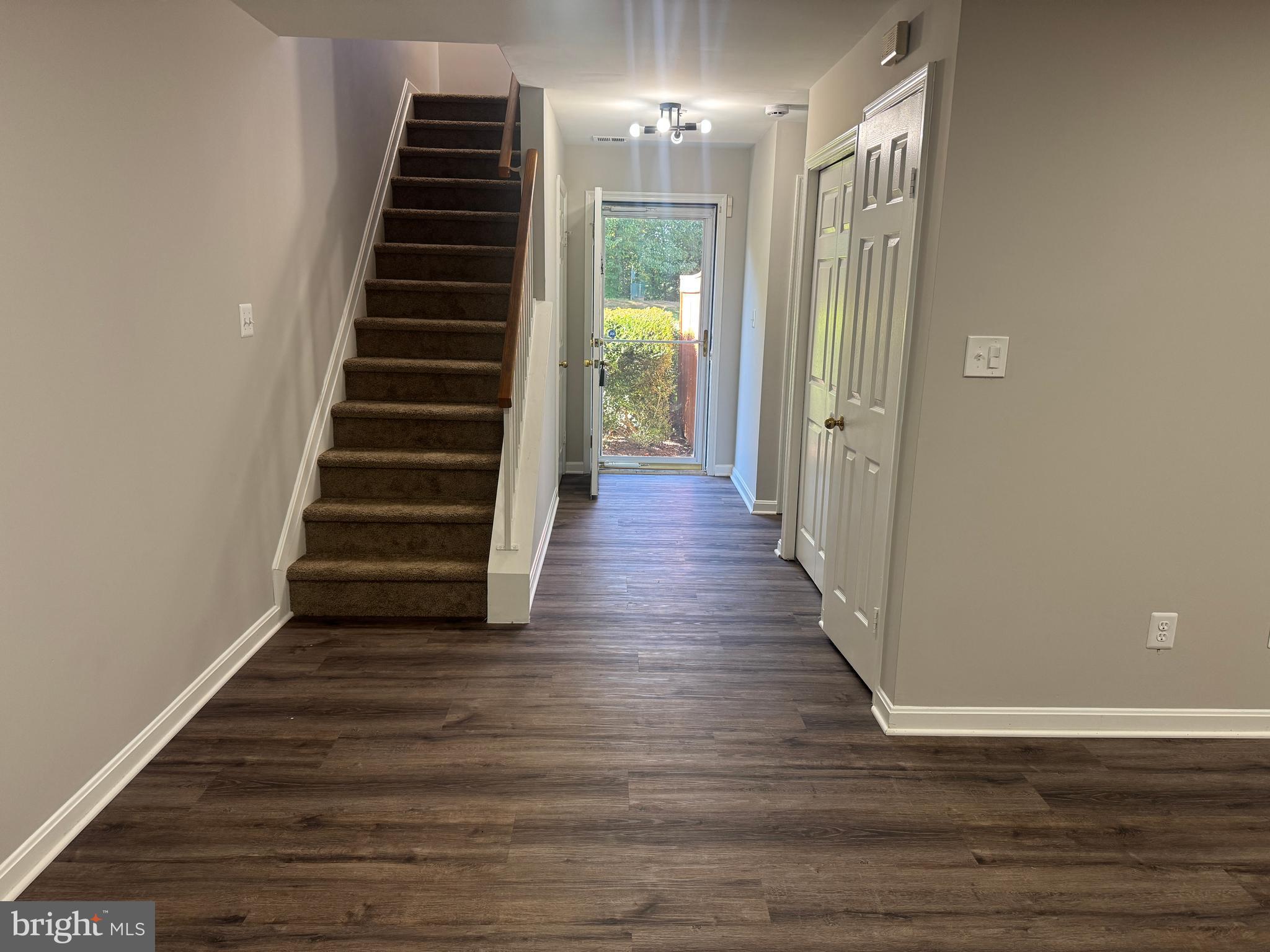 11263 Raging Brook Drive, Unit 253 Bowie, MD 20720 - Photo 6 of 22 a view of a hallway with wooden floor and stairs