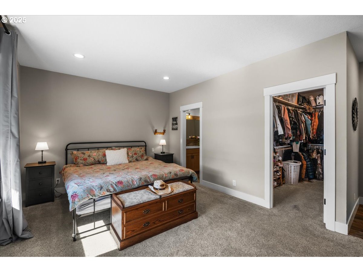 43300 Northwest Cedar Canyon Road Banks, OR 97106 - Photo 12 of 48 a bedroom with a bed and a view of bathroom