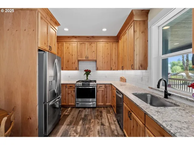 a backyard of a house with table and chairs