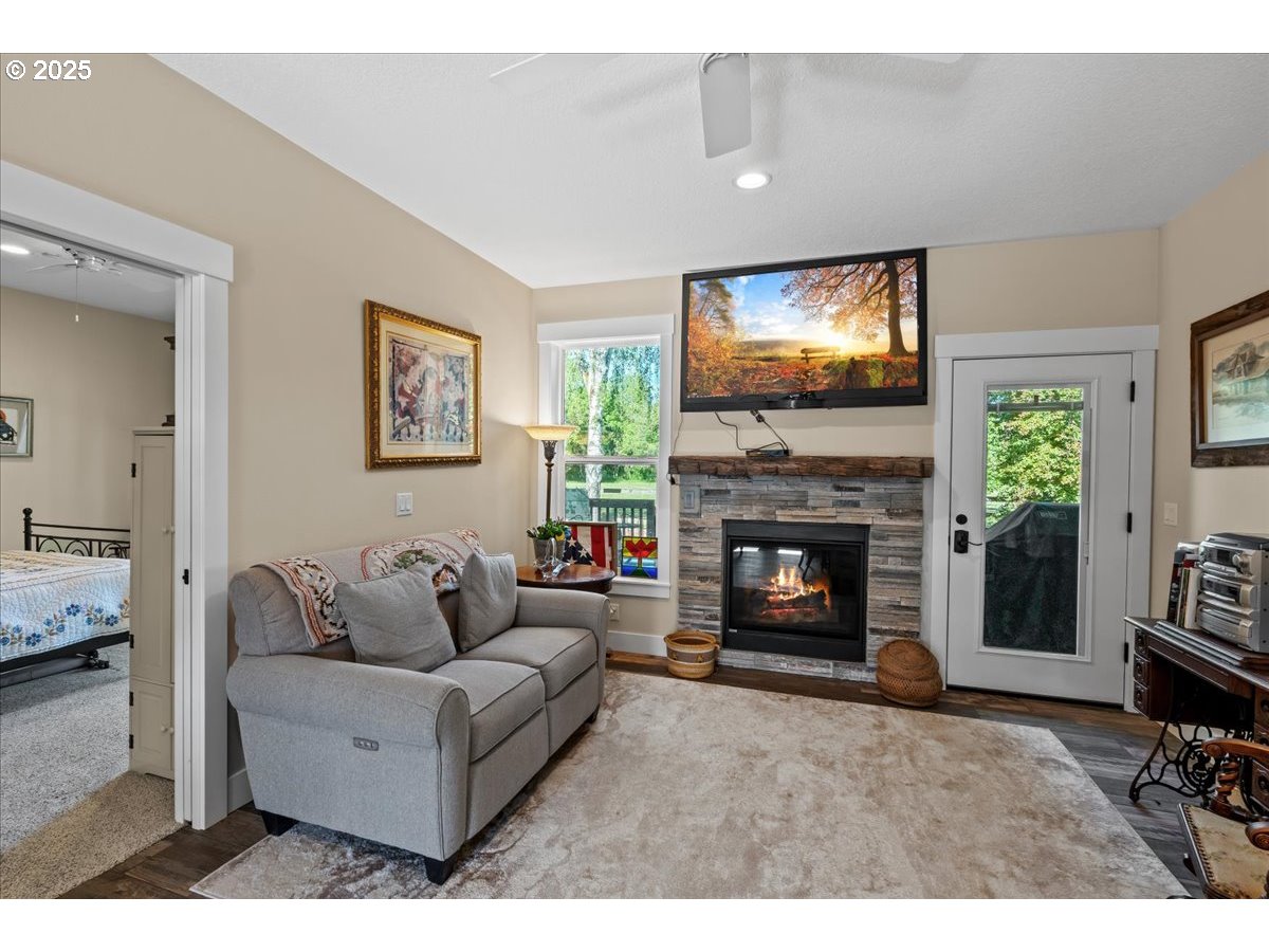 43300 Northwest Cedar Canyon Road Banks, OR 97106 - Photo 27 of 48 a living room with furniture a flat screen tv and a fireplace