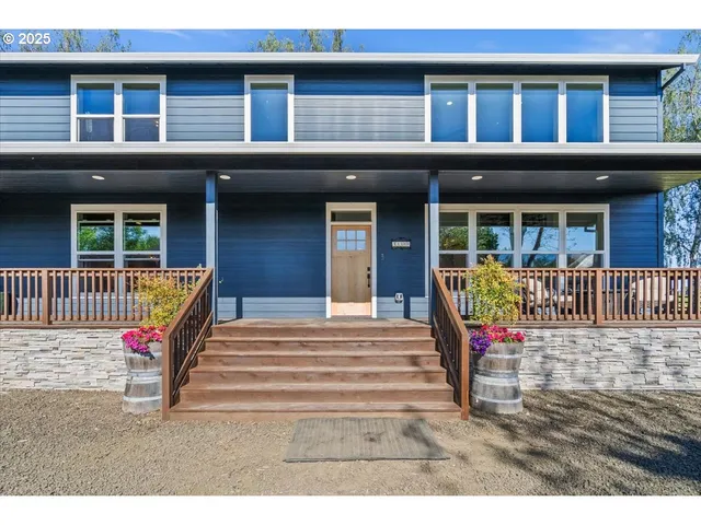 a kitchen with stainless steel appliances granite countertop a table chairs stove and refrigerator