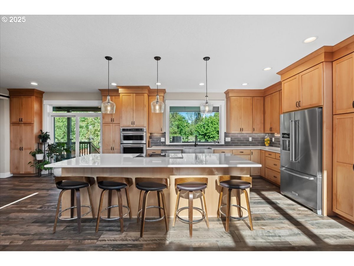 43300 Northwest Cedar Canyon Road Banks, OR 97106 - Photo 8 of 48 a kitchen with stainless steel appliances granite countertop a table chairs stove and refrigerator
