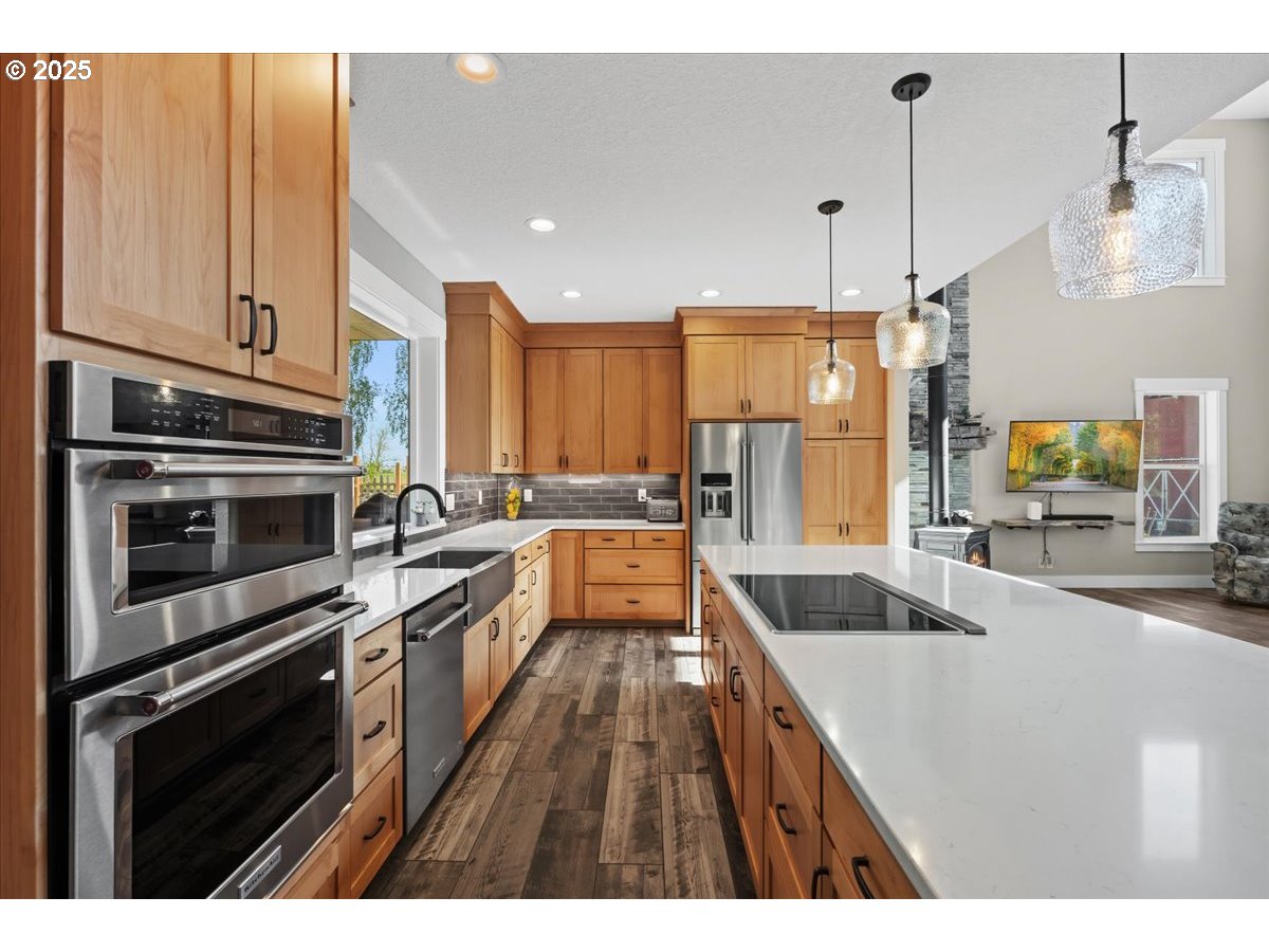 43300 Northwest Cedar Canyon Road Banks, OR 97106 - Photo 9 of 48 a kitchen with stainless steel appliances granite countertop a sink a stove and a refrigerator