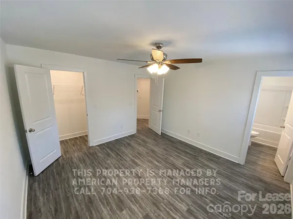 an empty room with wooden floor and window