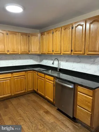 a kitchen with a sink cabinets and window
