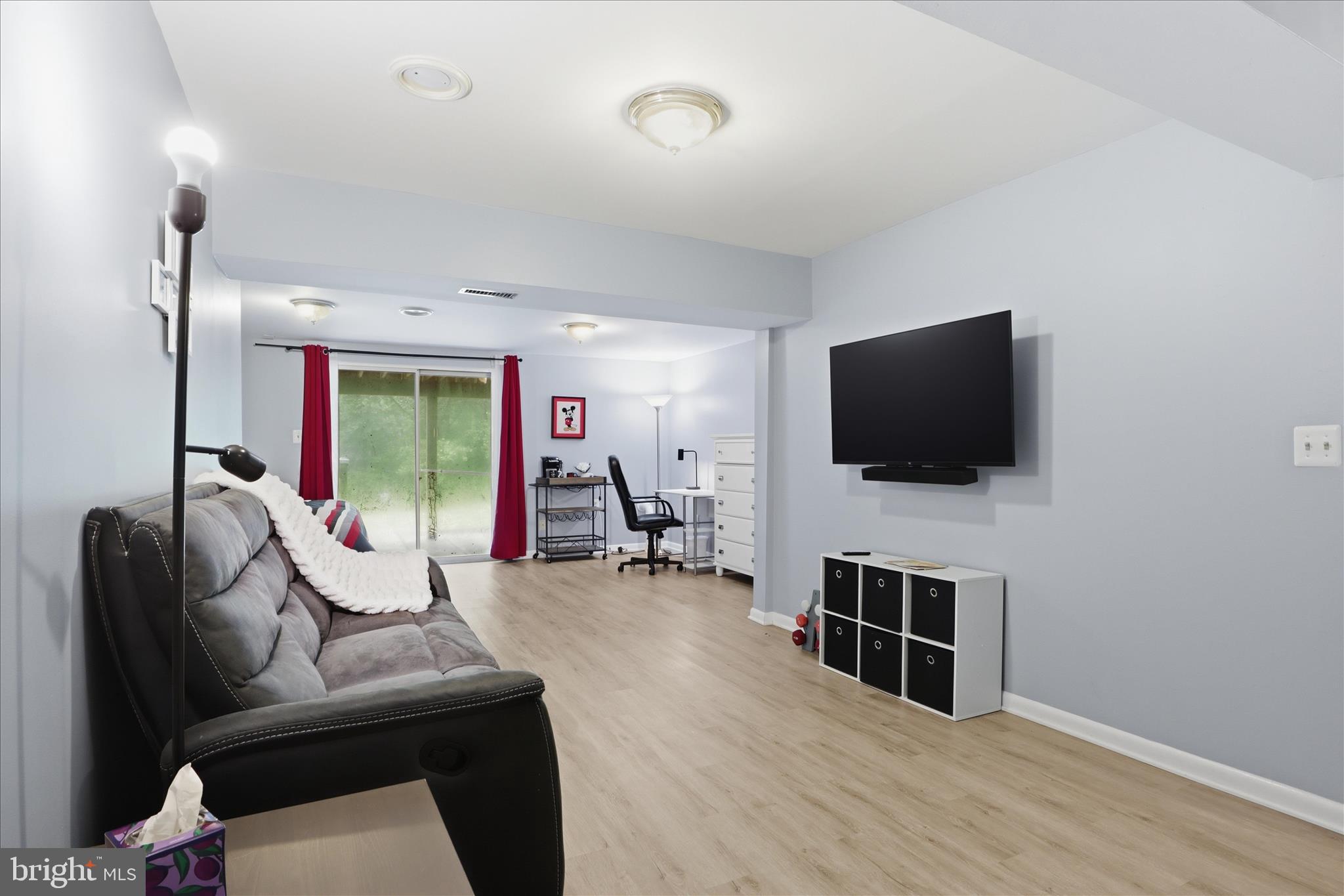 71 Kinsman View Circle Silver Spring, MD 20901 - Photo 12 of 42 a living room with furniture and a flat screen tv