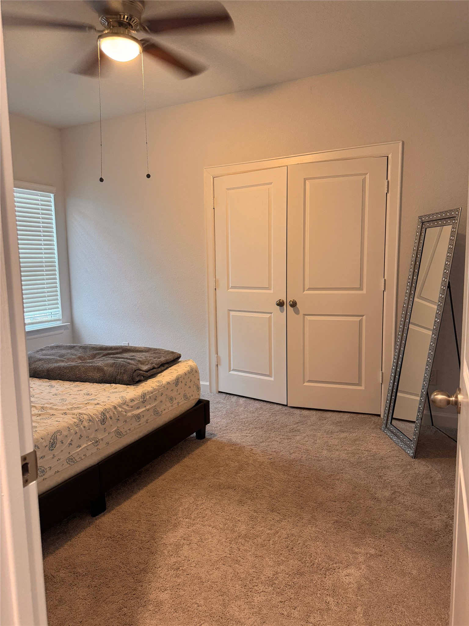650 Wild Pecan Loop Buda, TX 78610 - Photo 16 of 28 Carpeted bedroom with ceiling fan and a closet