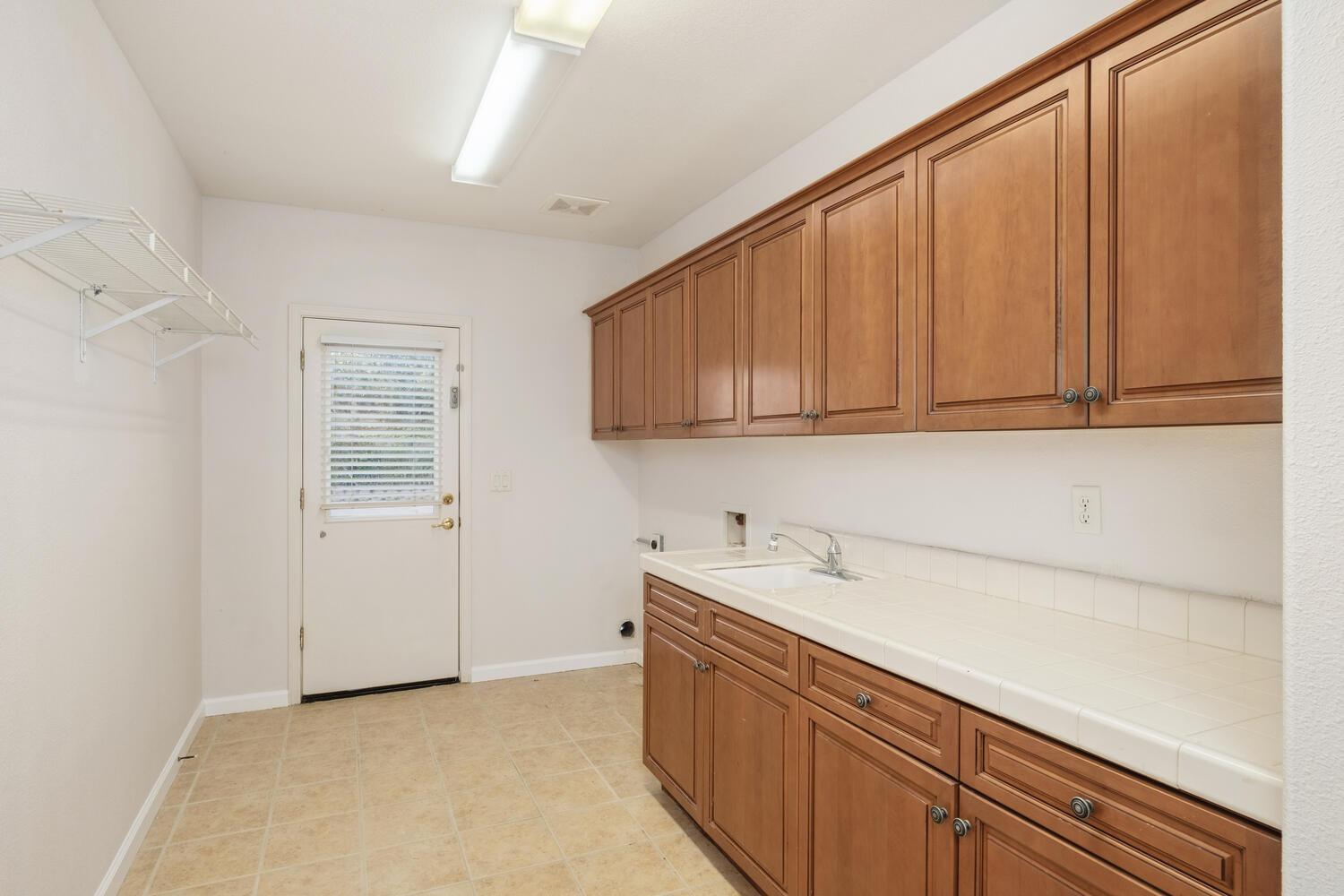 3331 Serena Avenue Clovis, CA 93619 - Photo 22 of 41 a kitchen with a sink and cabinets