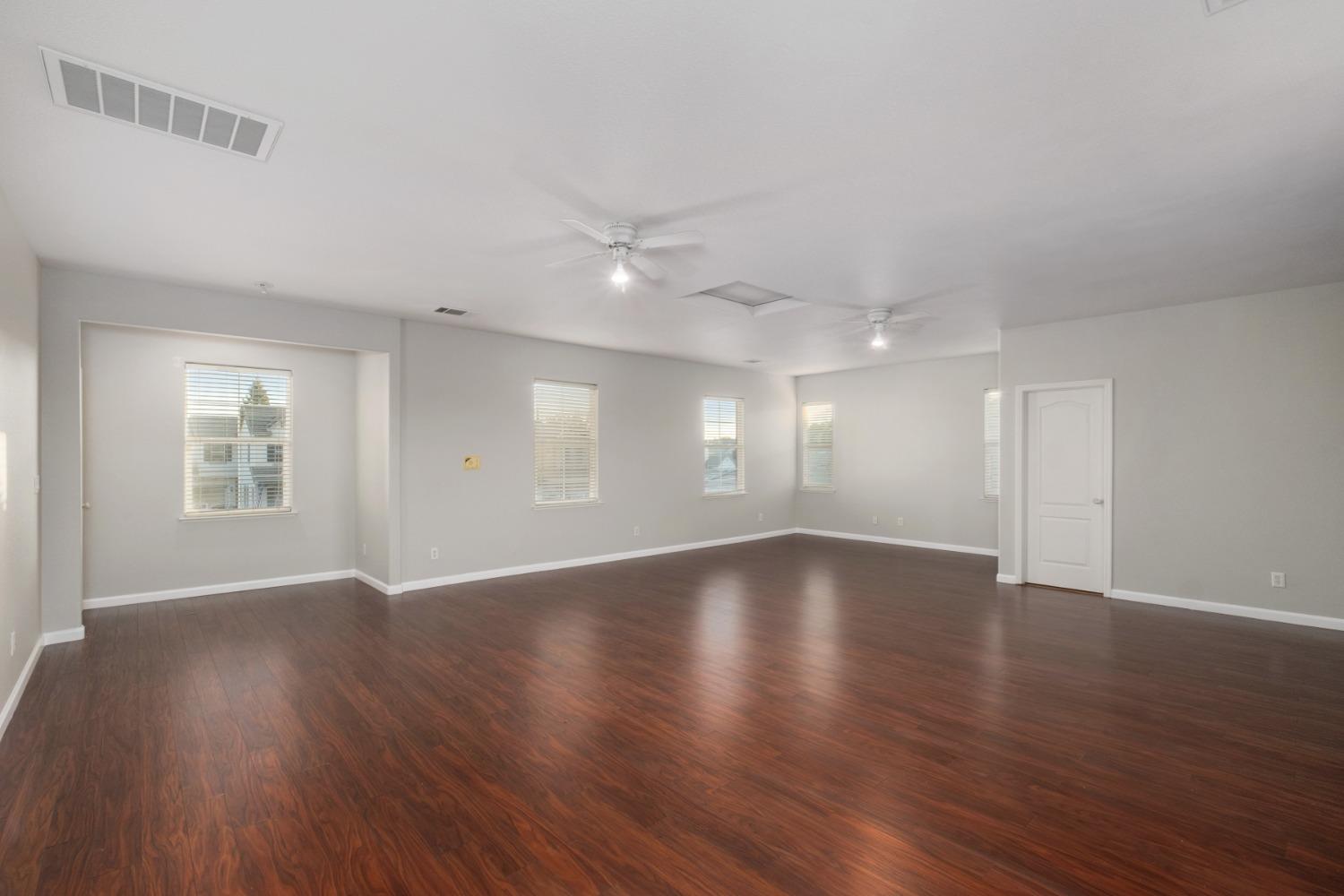 3331 Serena Avenue Clovis, CA 93619 - Photo 26 of 41 an empty room with wooden floor and windows